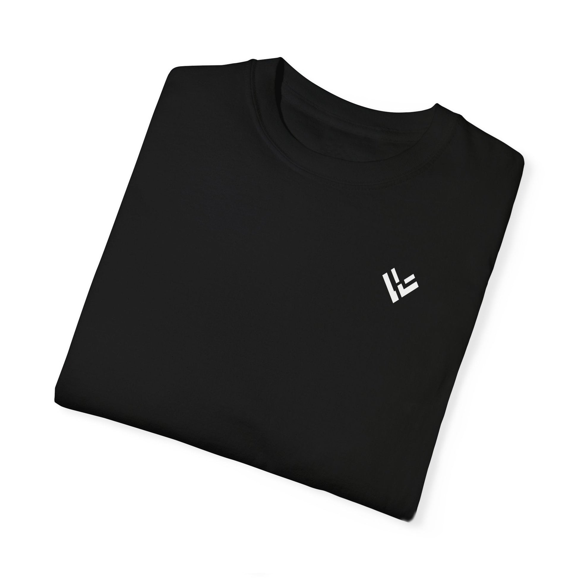 Folded view of the black Masculine Art cotton t-shirt, highlighting the fabric texture and the small white Vytal Motion (VM) logo on the left chest